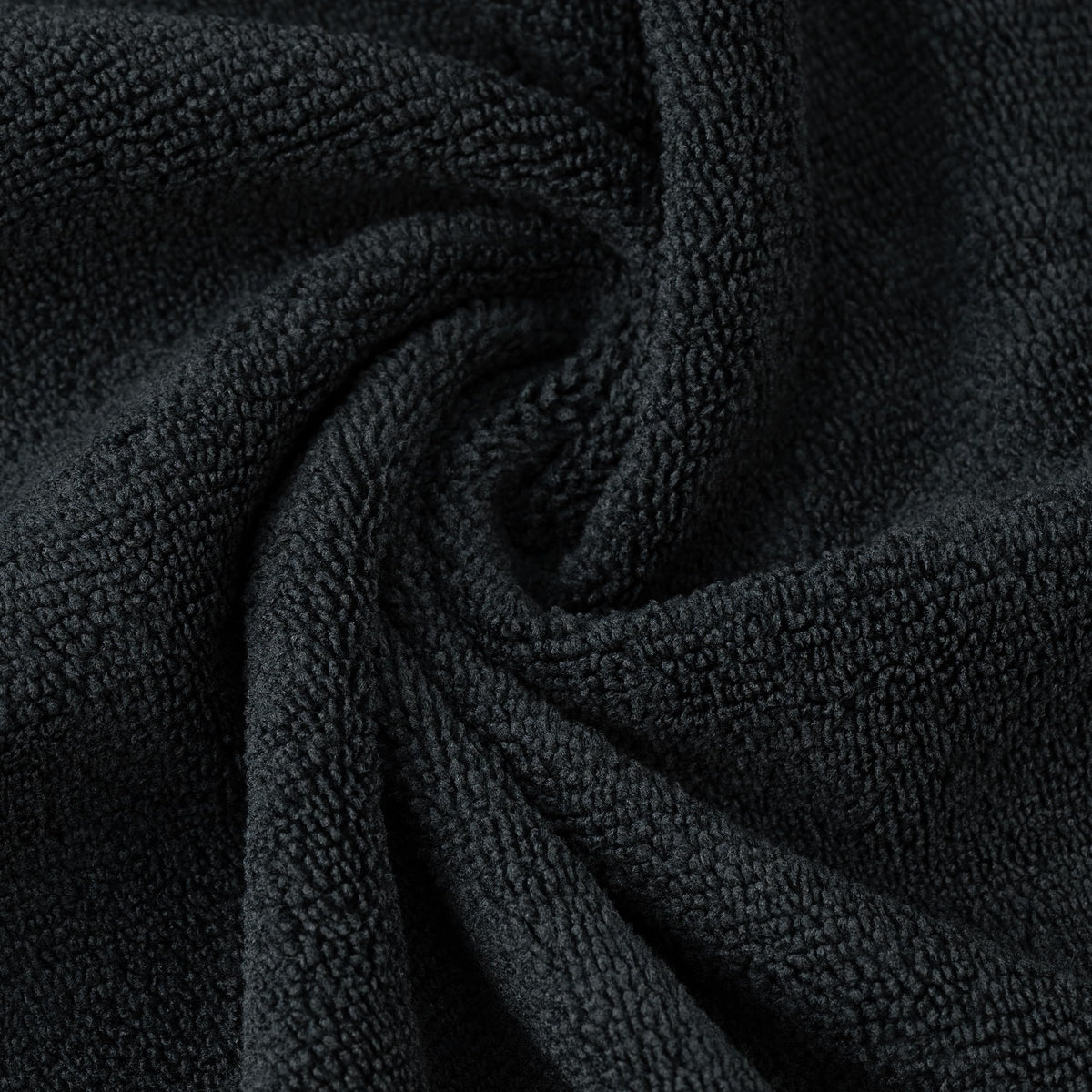 POLYTE towel next to hands for scale showing generous 16 by 29 inch coverage benefit