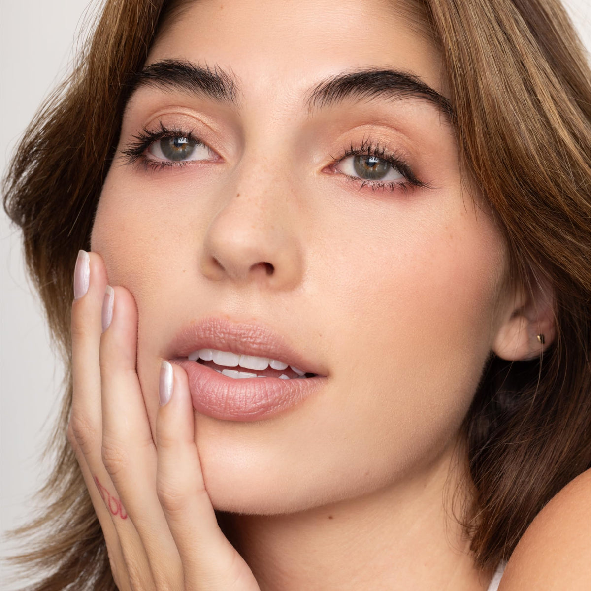 Poppy & Pout ingredients overhead with beeswax and coconut oil showing clean formulation benefit