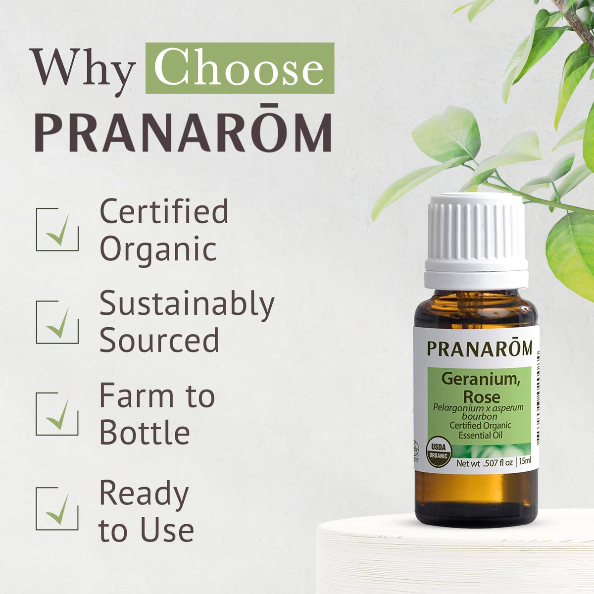 Pranarom rose geranium oil beside towel and candle in bathroom, suggests relaxation use