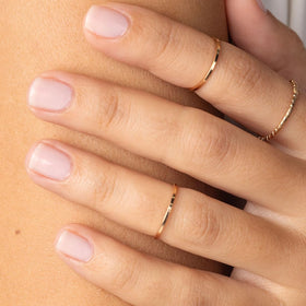 Bottle next to moisturized cuticles illustrating Probelle nourishing benefit