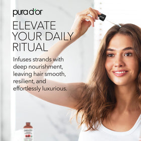 PURA D'OR hair treatment in hands showing easy absorption and shine