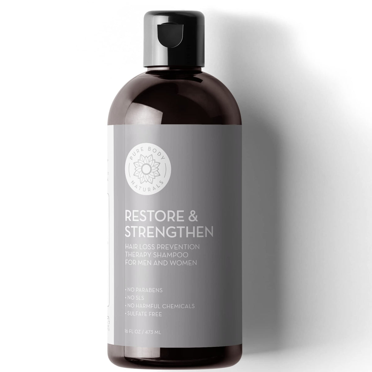 Pure Body Naturals front packaging showing bottle and woodsy scent benefits