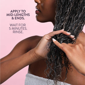 Pureology rinsed hair back view showing glossy, humidity‑resistant finish