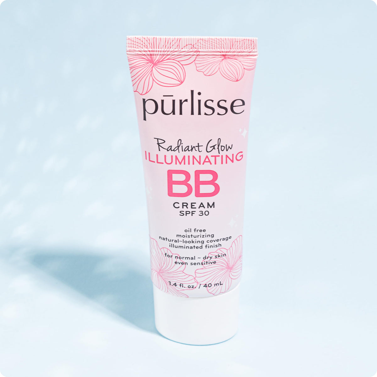 pūrlisse BB cream held in hand showing 1.4 oz size for travel convenience