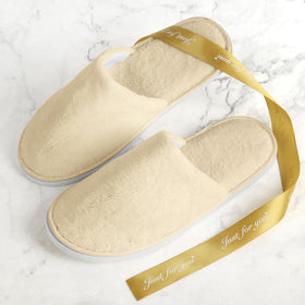 QatmMkt slippers on bedroom floor illustrating guest-ready comfort