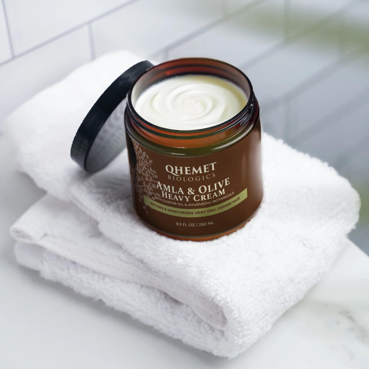 Qhemet Biologics open jar texture close-up demonstrating creamy, thick moisture