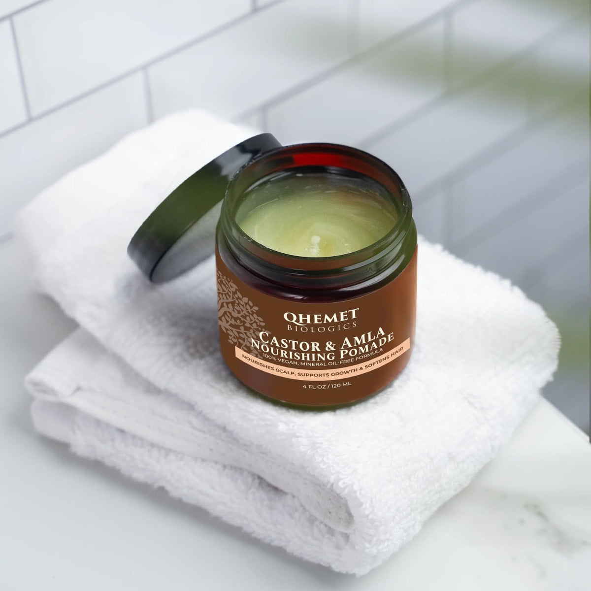 Qhemet Biologics pomade texture in jar emphasizing creamy moisturizing feel