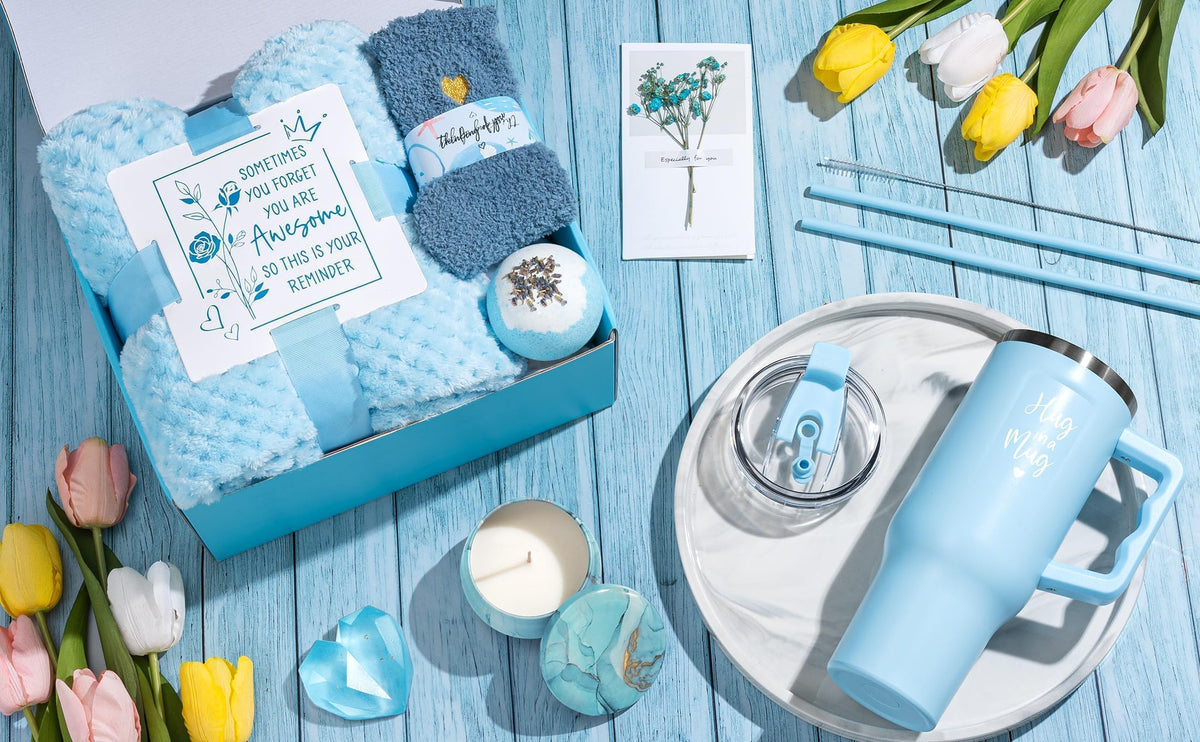 Qinline lifestyle scene with blanket, candle and tumbler creating a relaxing at-home spa vibe
