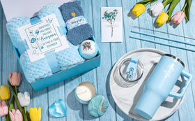 Qinline lifestyle scene with blanket, candle and tumbler creating a relaxing at-home spa vibe