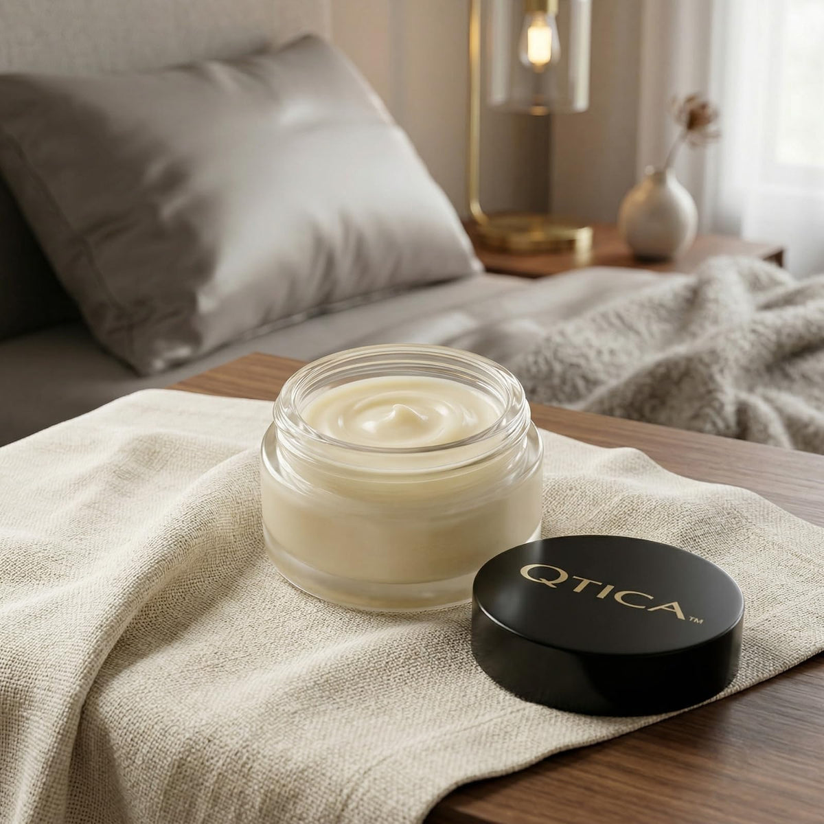 QTICA balm being applied to cuticle, demonstrating targeted hydration benefit