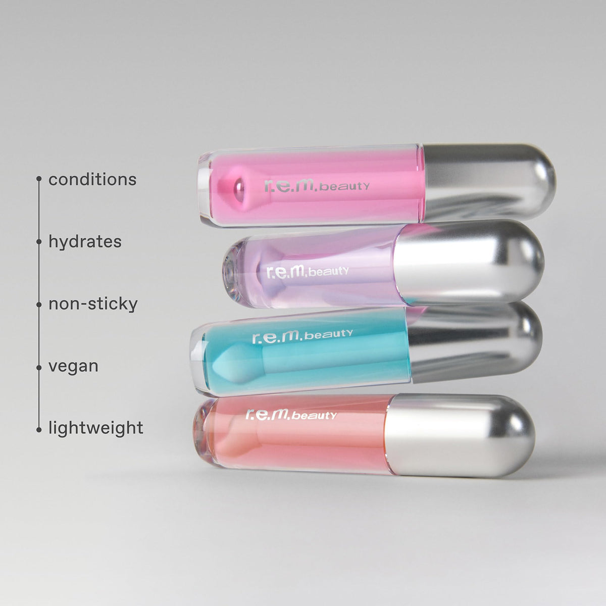 r.e.m. beauty oil texture swatched on skin to show sheer raspberry color and glossy finish