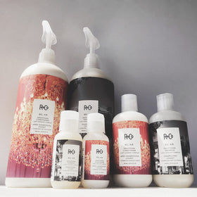 R+Co Bel Air applied to wet hair in shower, shows smooth detangling benefit