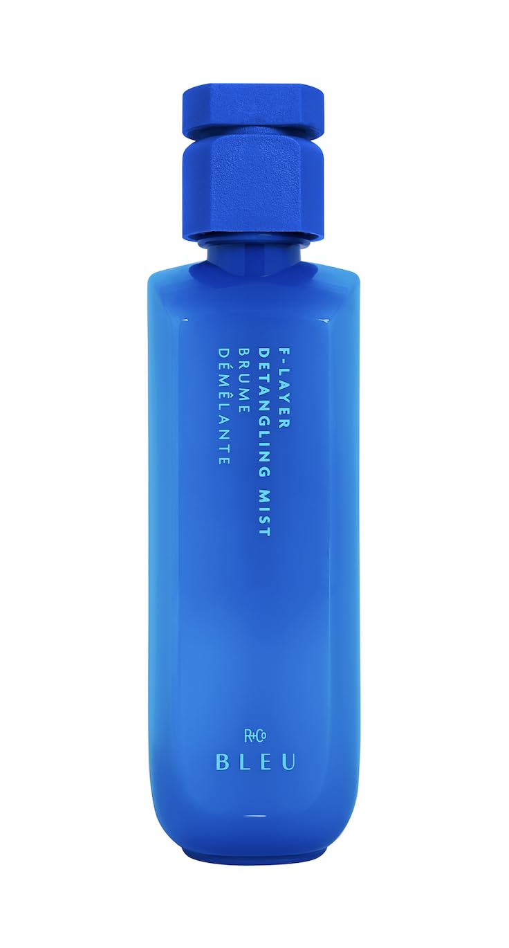 R+Co BLEU F-Layer front packaging showing label and bottle — clear product identity and lightweight benefits