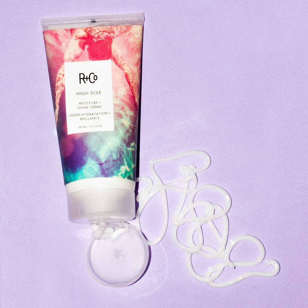 R+Co HIGH DIVE next to a coin illustrating 50 ml size for travel-friendly convenience
