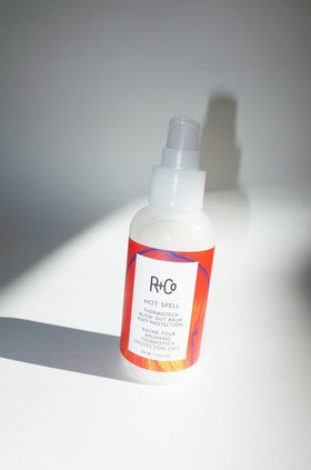 R+Co Hot Spell shown next to hand for scale highlighting the 4.2 oz size convenience