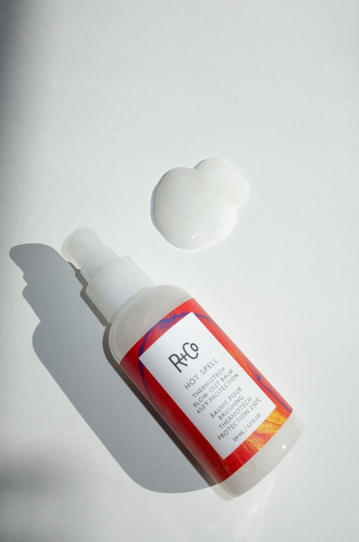 R+Co Hot Spell balm texture closeup illustrating creamy transformation and smooth application