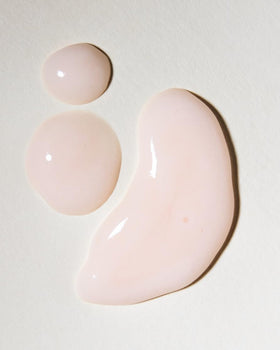 Rahua shampoo bottle next to hand showing bottle size and travel practicality