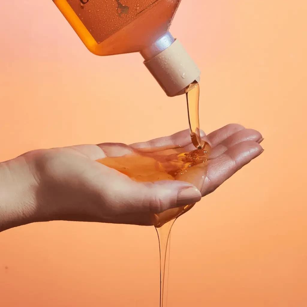 Rahua bottle held in hand to show size and travel-friendly benefit