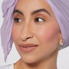 Rare Beauty liquid blush texture on dropper highlighting smooth, blendable formula benefits
