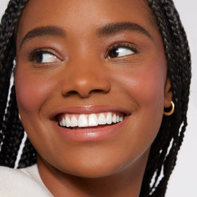 Rare Beauty application with fingertip demonstrating easy blending and natural finish advantages