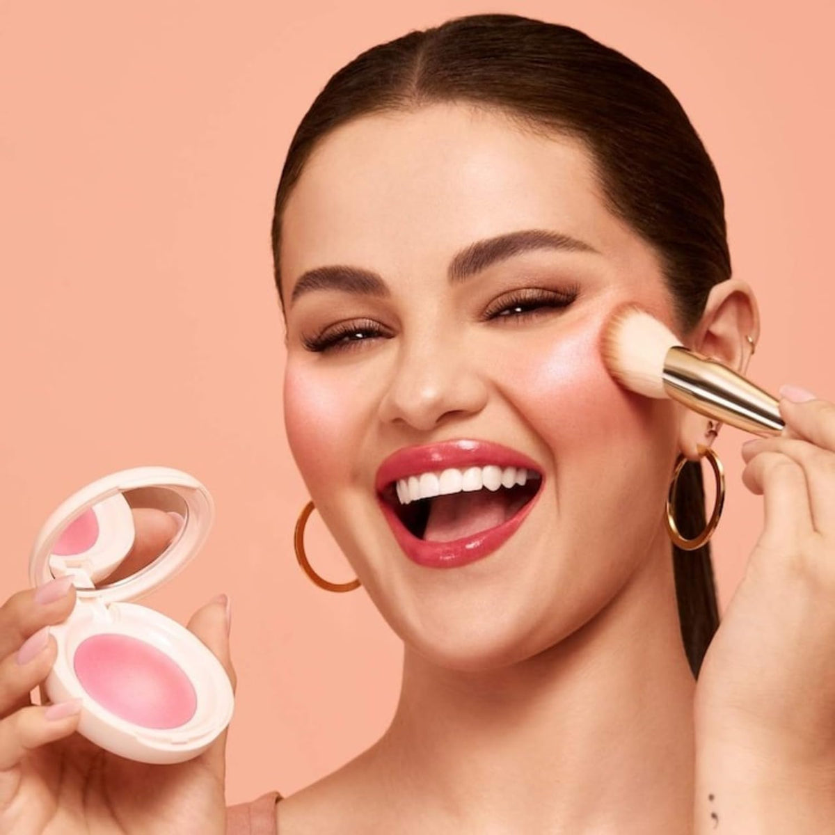 Rare Beauty applied on model cheek creating natural rosy glow for everyday wear