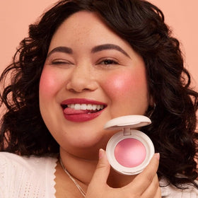 Rare Beauty compact next to a coin to show size and portability benefit