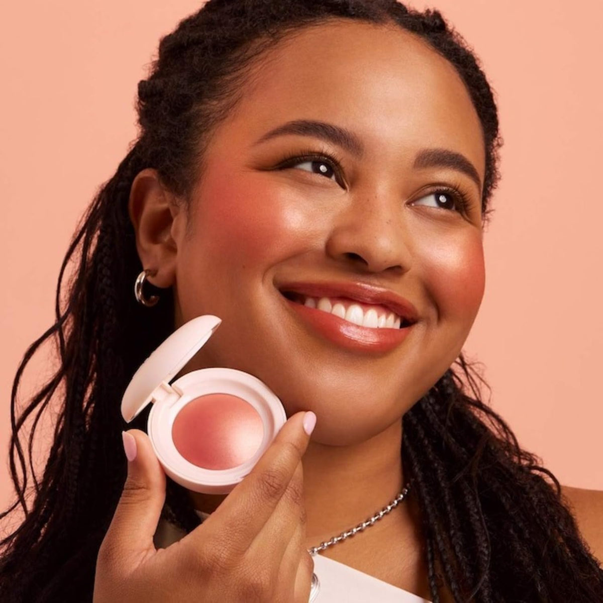 Rare Beauty blush on brush demonstrating soft pickup and even application