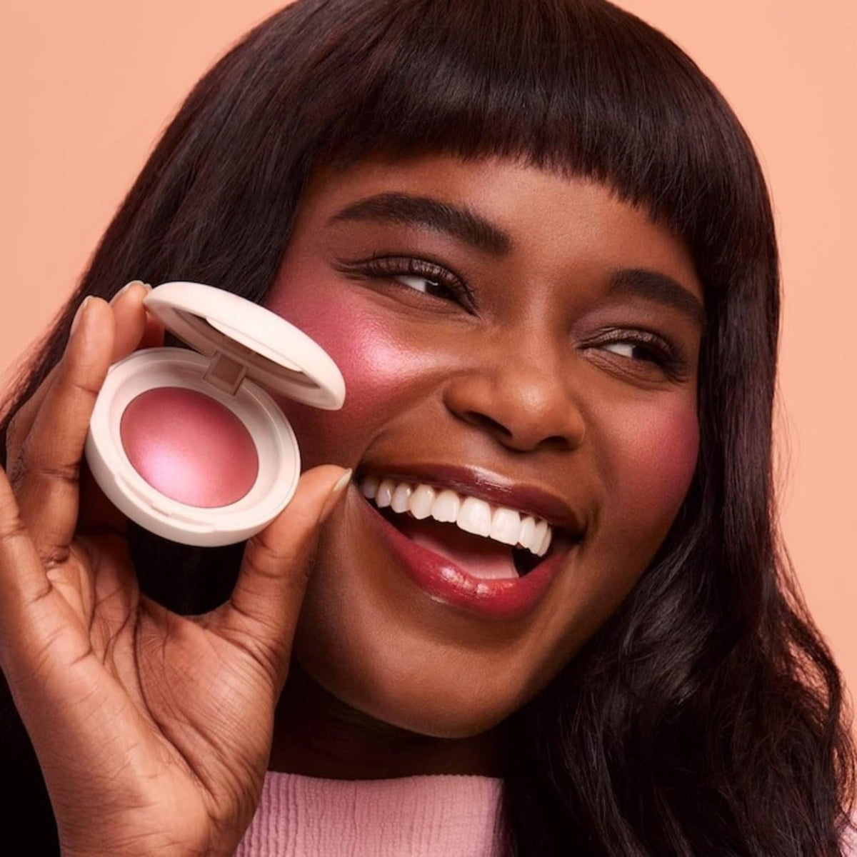 Rare Beauty brush picking up pigment to show buildable color control