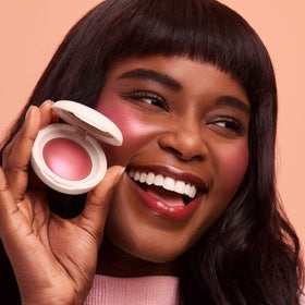 Rare Beauty brush picking up pigment to show buildable color control