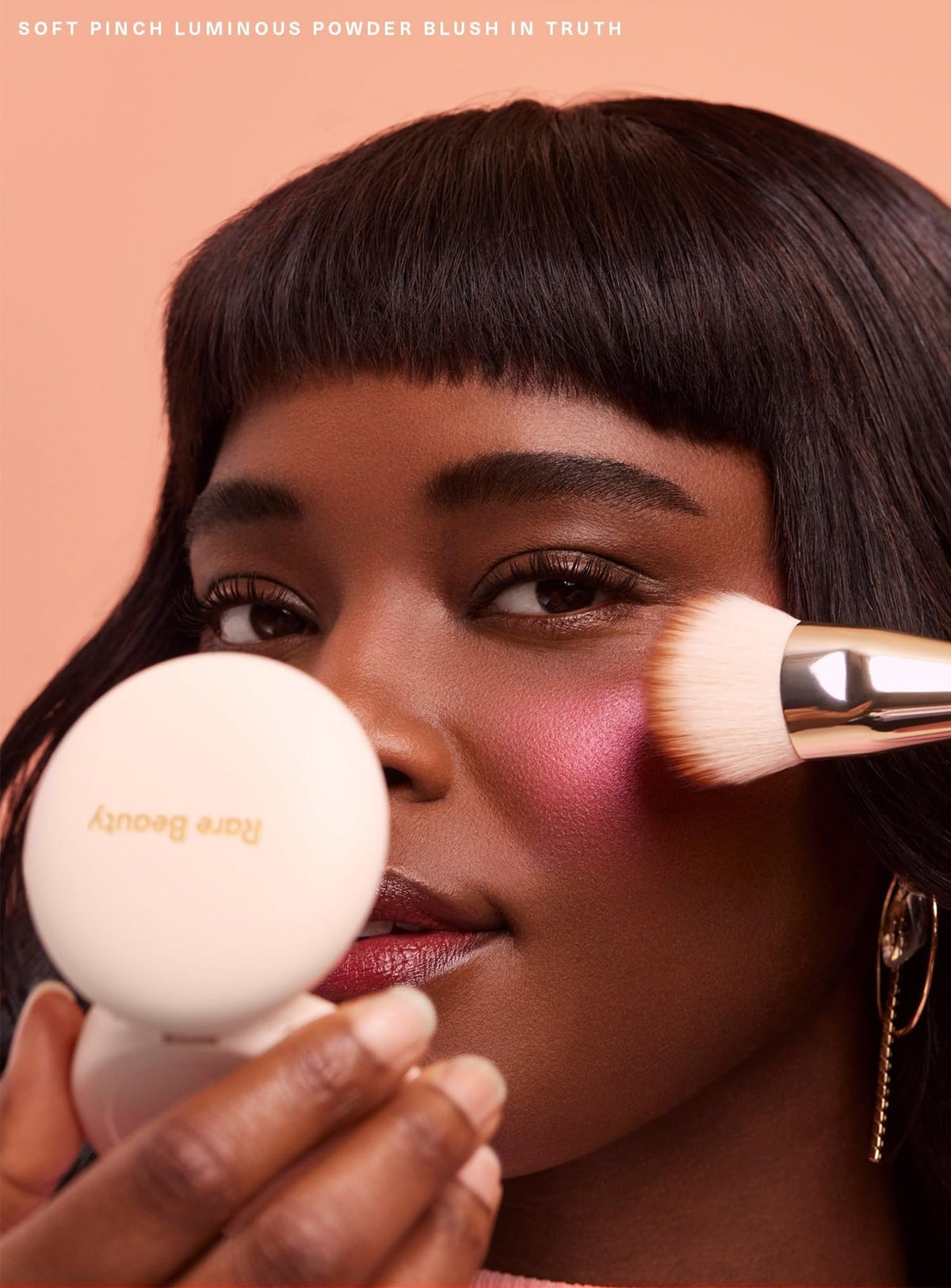 Rare Beauty applied on cheek demonstrating blendability and natural glow