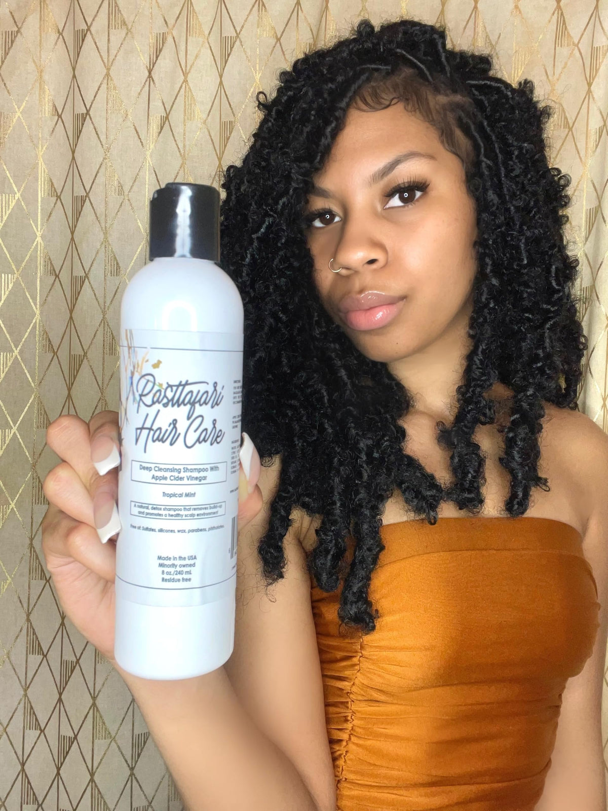 Rasttafari Hair Care bottle side view with pump, highlighting packaging usability