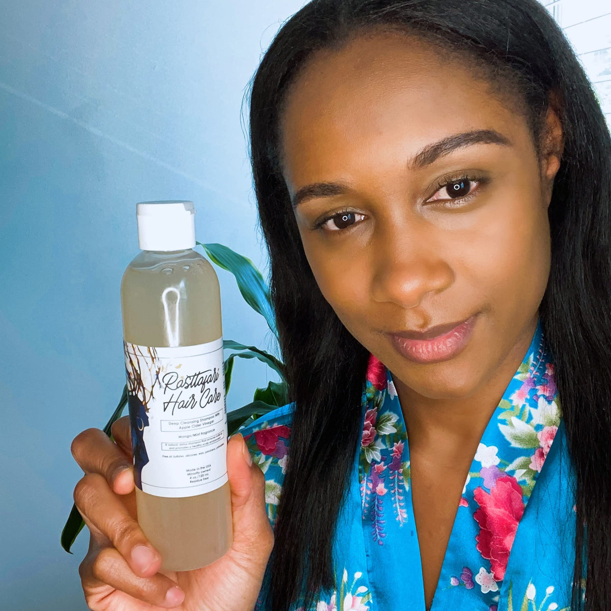 Rasttafari Hair Care next to a measuring cup to show the 8 oz bottle scale