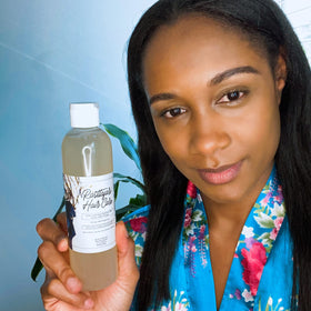 Rasttafari Hair Care next to a measuring cup to show the 8 oz bottle scale