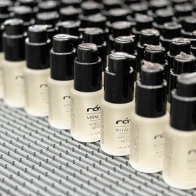 Raya Vital Silk Serum beside coin to show compact travel-friendly size