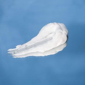 R+Co ANALOG model with smooth shiny hair after use demonstrating frizz control and shine
