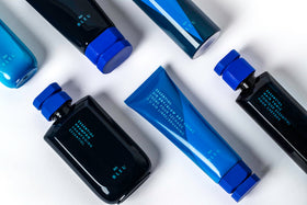R+Co BLEU 4.2 oz bottle next to a ruler to show compact, travel-friendly size