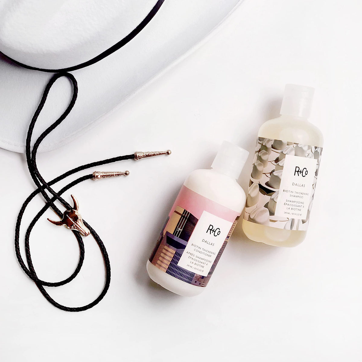 R+Co Dallas in-shower application showing gentle massaging into scalp for fuller-looking results