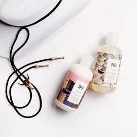 R+Co Dallas in-shower application showing gentle massaging into scalp for fuller-looking results