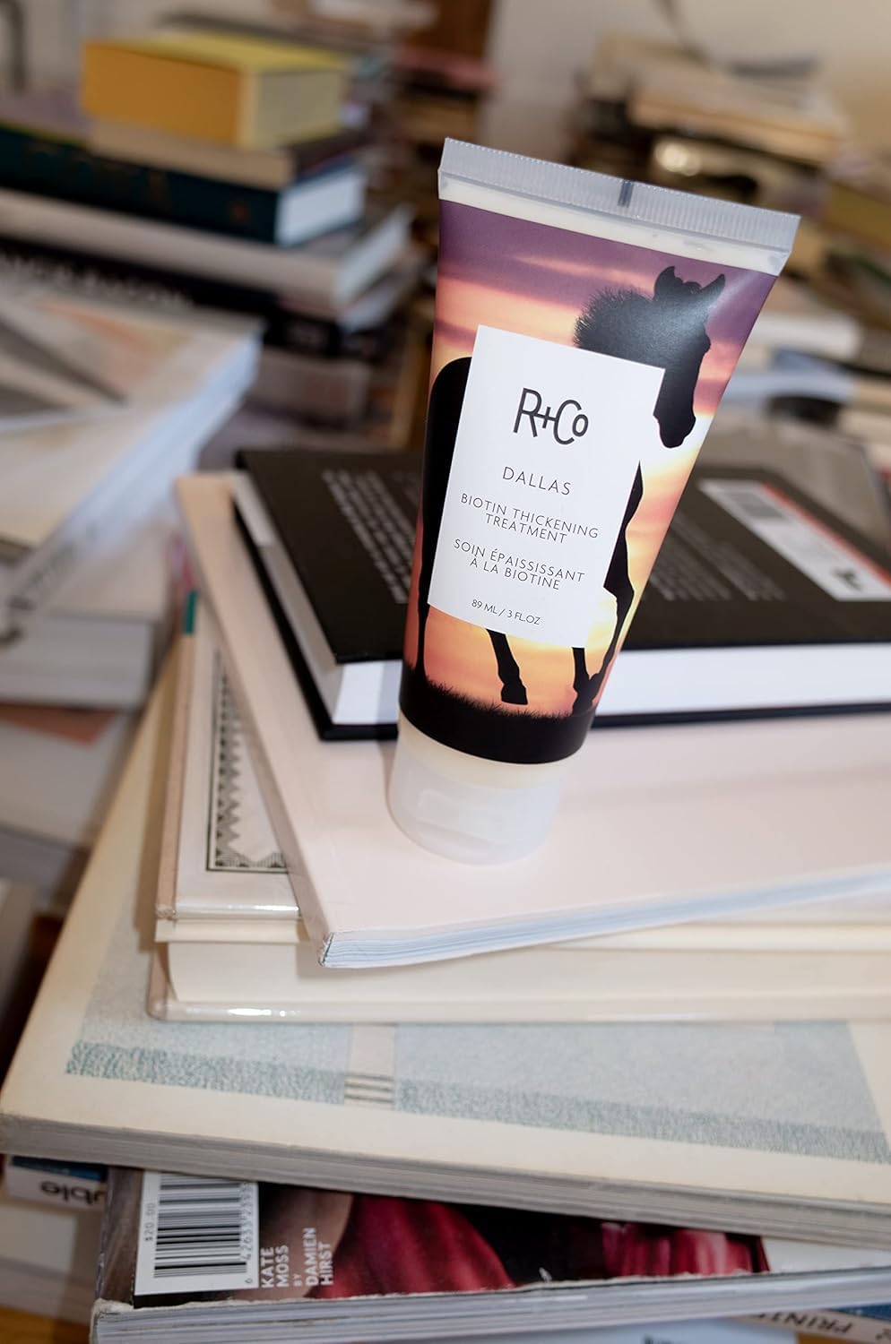 R+Co Dallas size scale beside three-ounce bottle showing accurate sizing