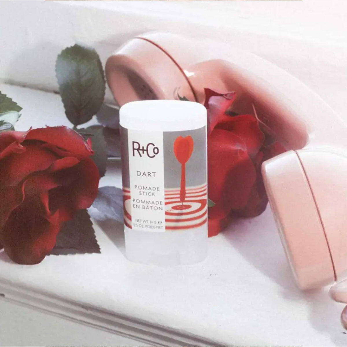 R+Co Dart Pomade Stick pack of two inside a bag for travel-ready styling confidence