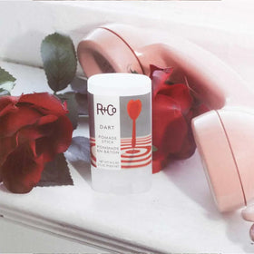 R+Co Dart Pomade Stick pack of two inside a bag for travel-ready styling confidence