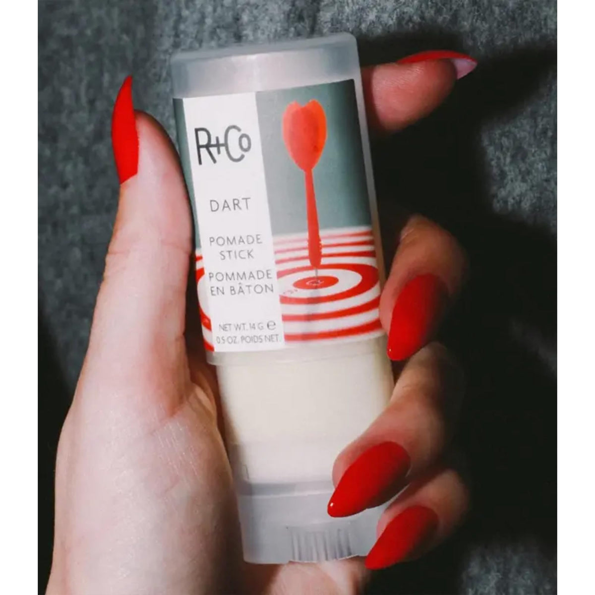 R+Co Dart Pomade Stick in hand for scale showing pocket-friendly convenience