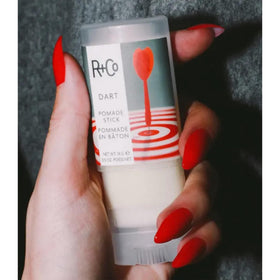 R+Co Dart Pomade Stick in hand for scale showing pocket-friendly convenience
