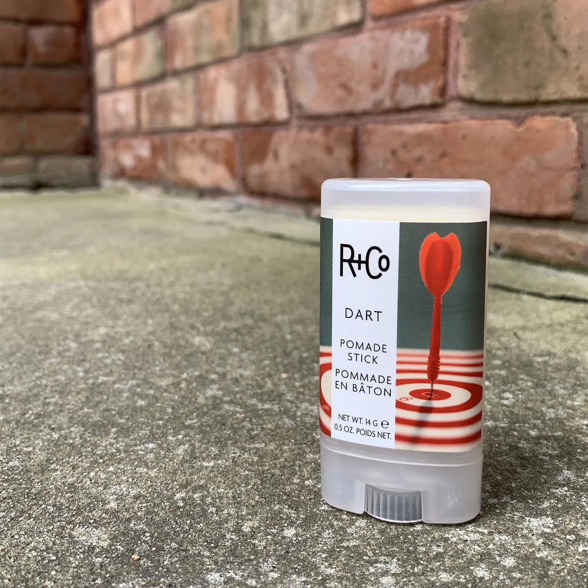 R+Co Dart Pomade Stick used to create a sleek finished hairstyle with natural shine