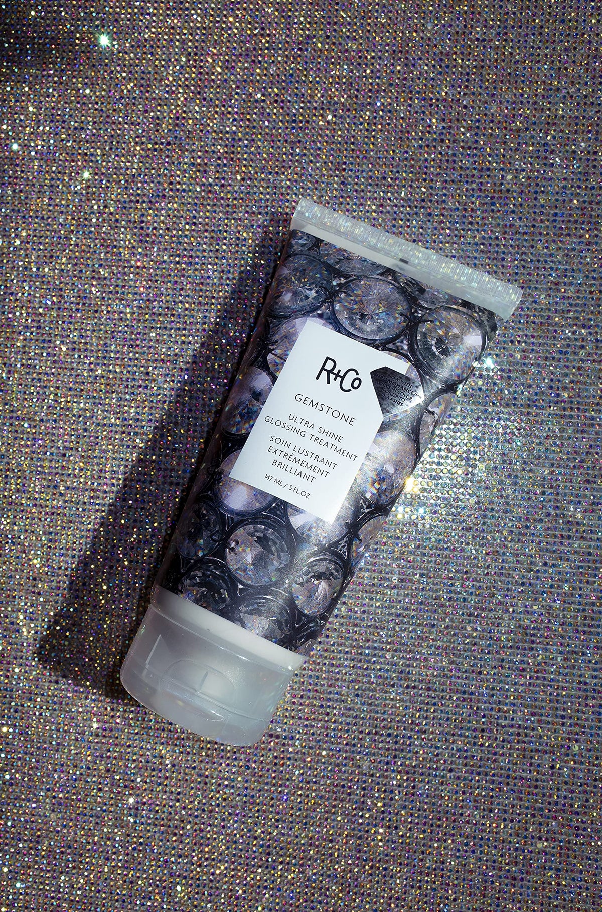 R+Co Gemstone applied in hand demonstrating smooth cream and simple styling benefit