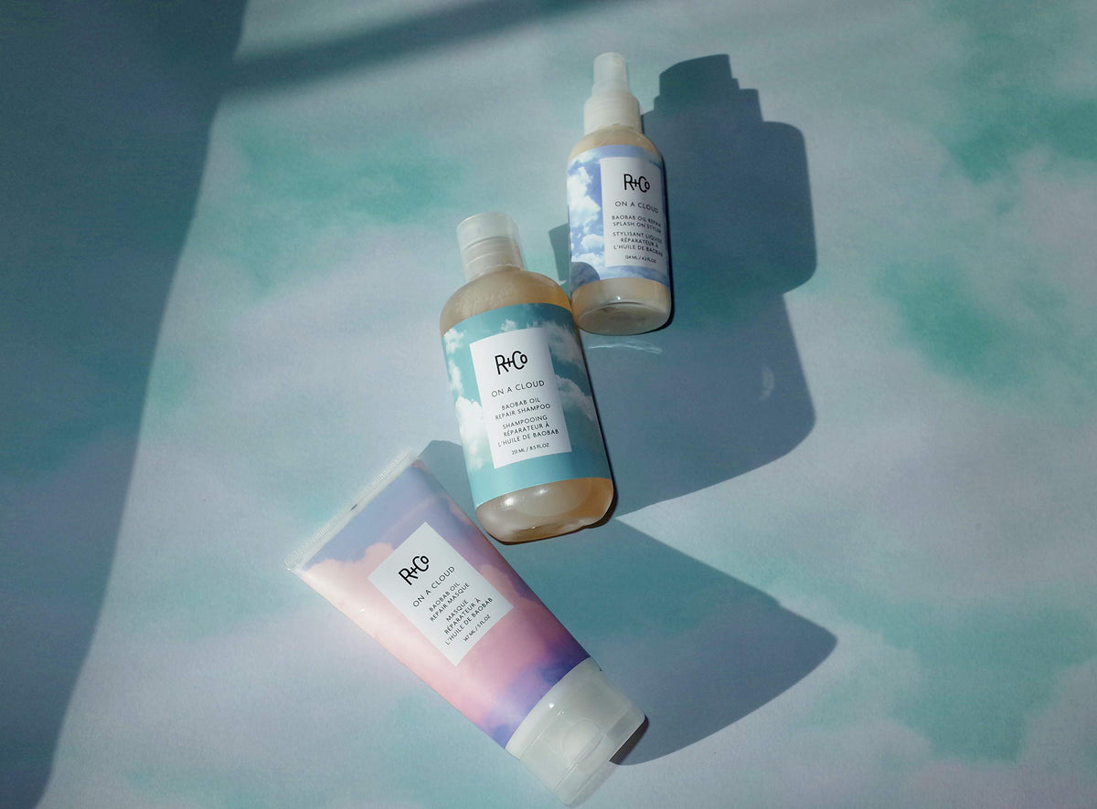 R+Co being spritzed on damp hair to illustrate detangling and blow-dry smoothing benefits