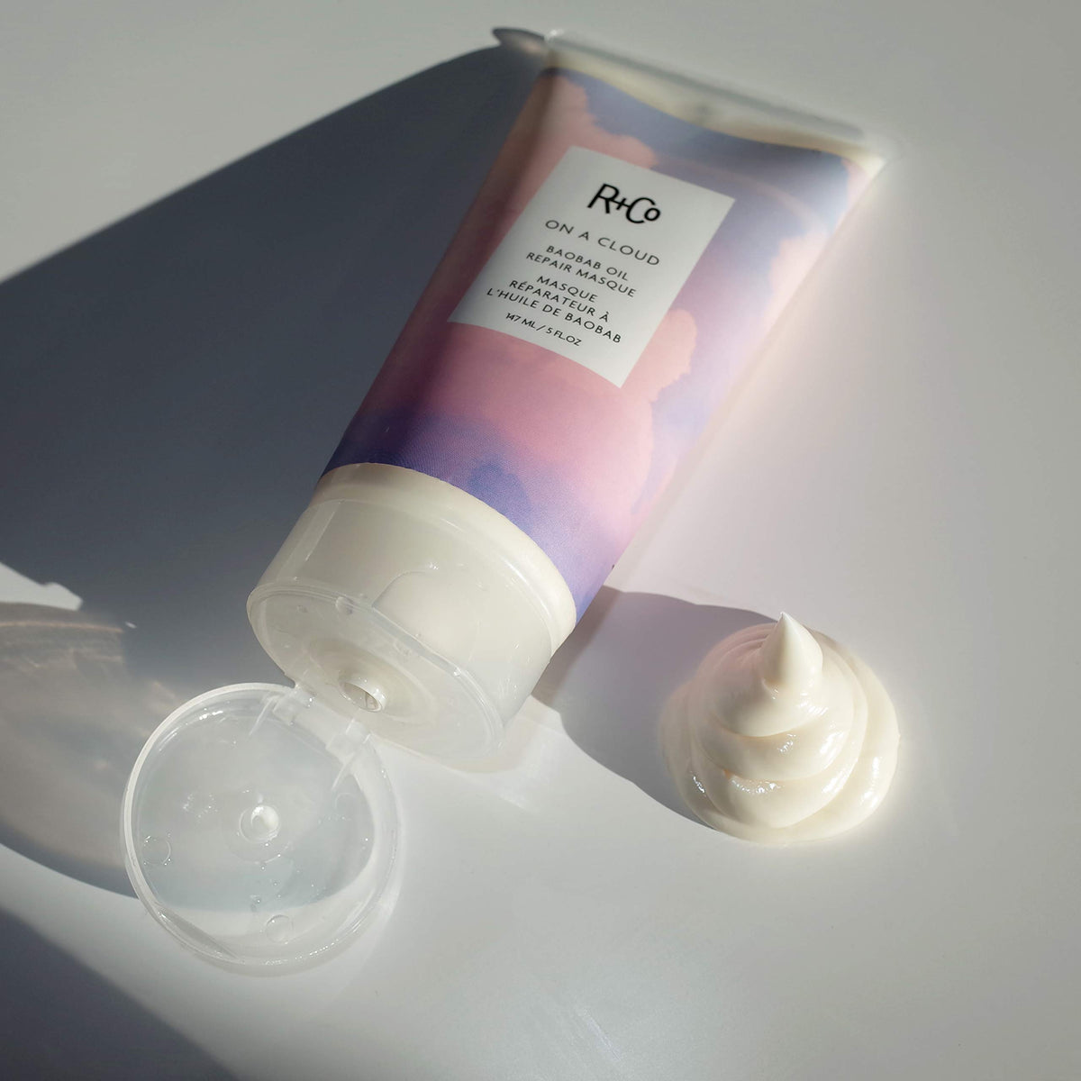 R+Co on a cloud applying to hair in shower, nourishing treatment improving manageability