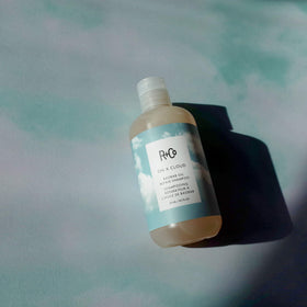 R+Co bottle held in hand for scale demonstrating convenient 251 ml size