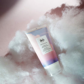 R+Co on a cloud ingredient bottle with baobab mix, botanical oils for protection