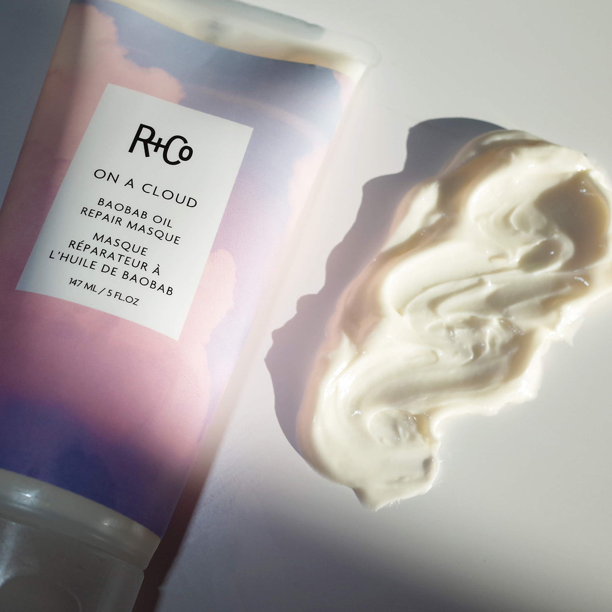 R+Co on a cloud size comparison 147ml scale, compact jar ideal for travel